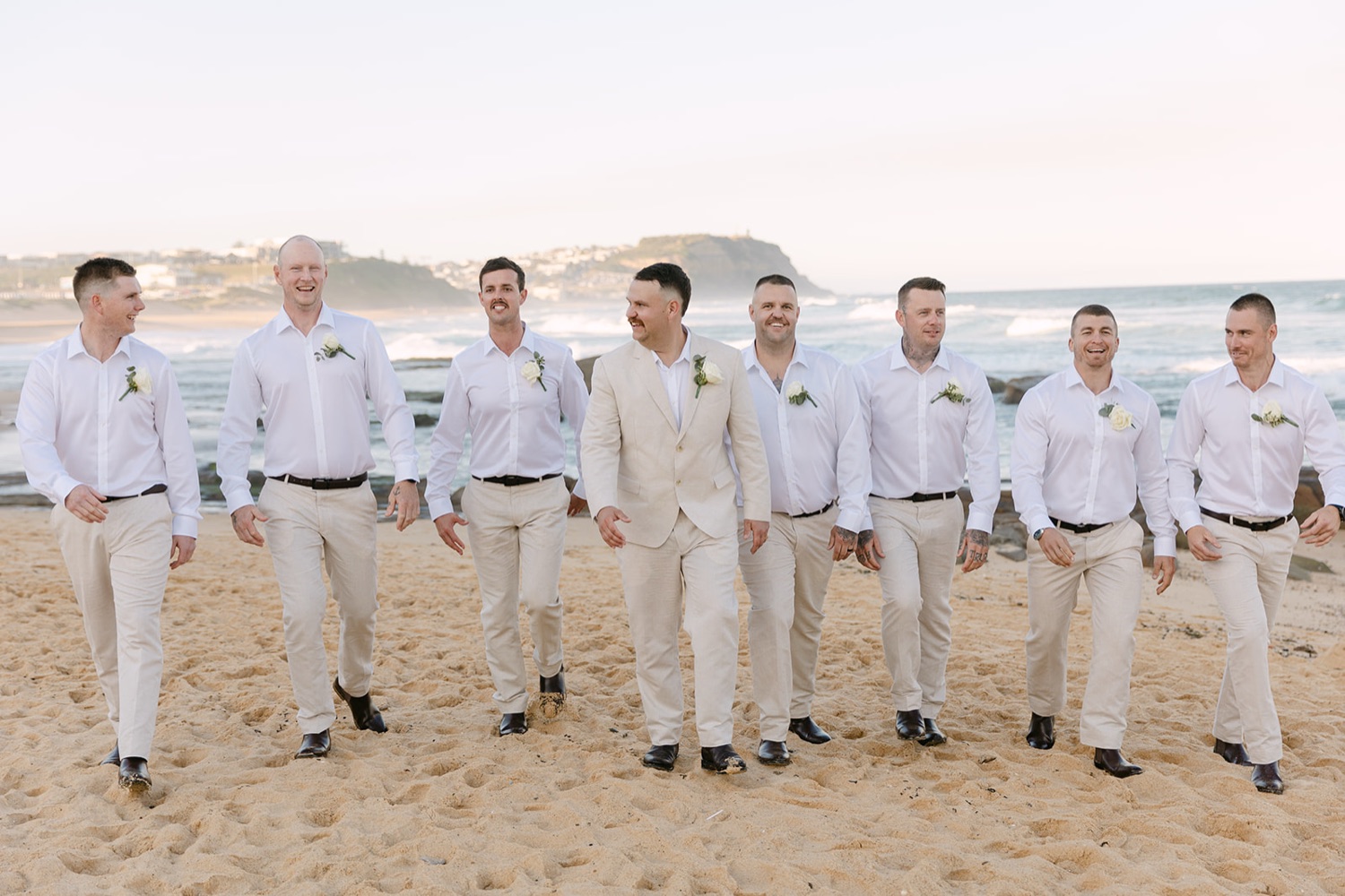 The wedding party on the beach. Jasmin & Jye's wedding at Merewether Surfhouse & Ocean Baths, Newcastle