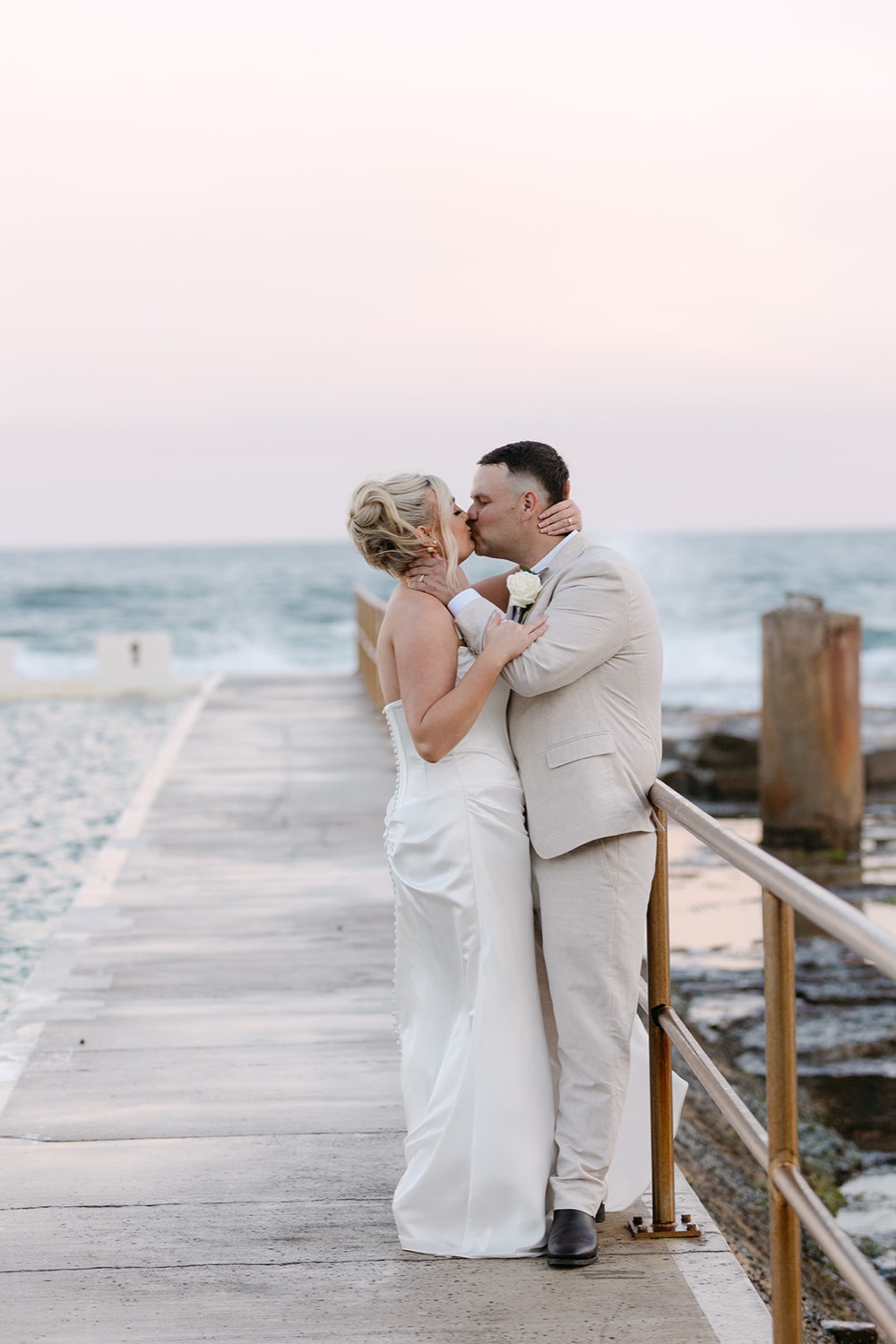 A kiss on the ocean baths wall. Jasmin & Jye's wedding at Merewether Surfhouse & Ocean Baths, Newcastle