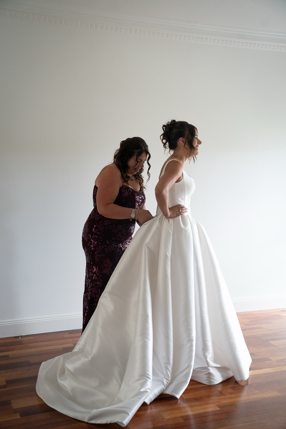 Doing up the dress. Jasmine & Joshua's wedding at The Lakehouse, North Richmond, Sydney