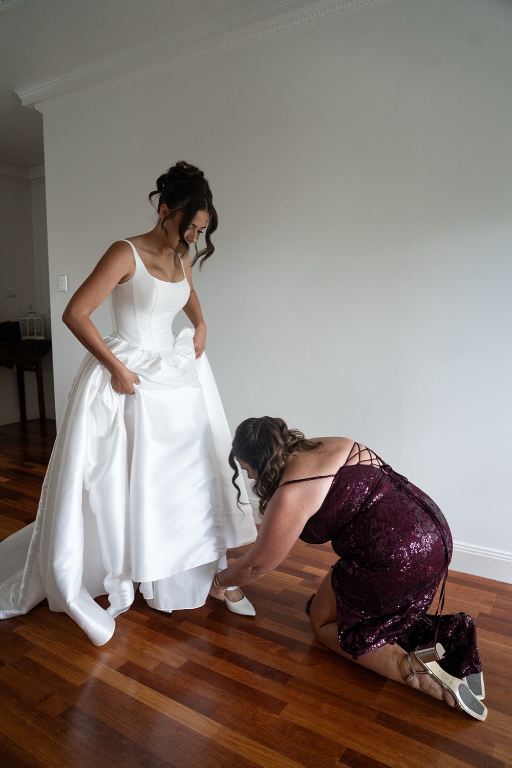 Fixing the hem of the dress. Jasmine & Joshua's wedding at The Lakehouse, North Richmond, Sydney