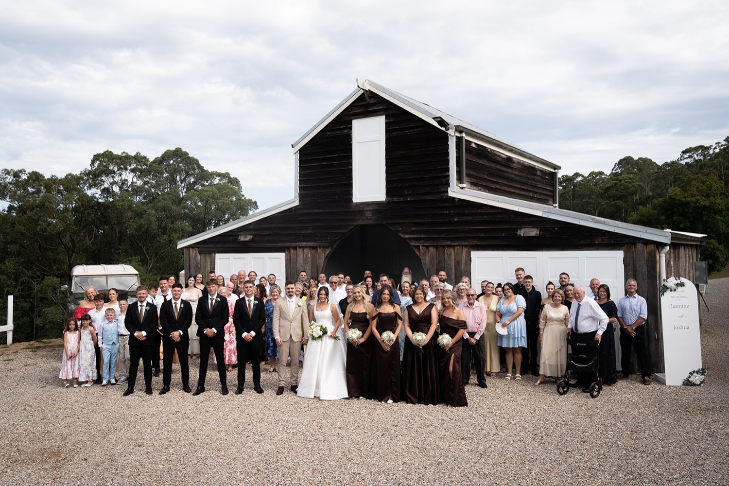 Group photo outside the barn. Jasmine & Joshua's wedding at The Lakehouse, North Richmond, Sydney