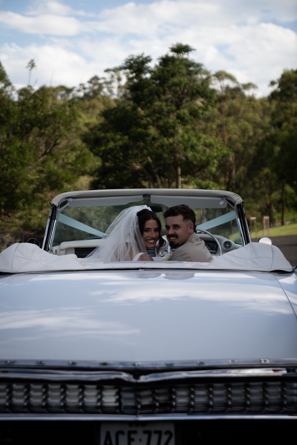 Driving off in the vintage convertible. Jasmine & Joshua's wedding at The Lakehouse, North Richmond, Sydney