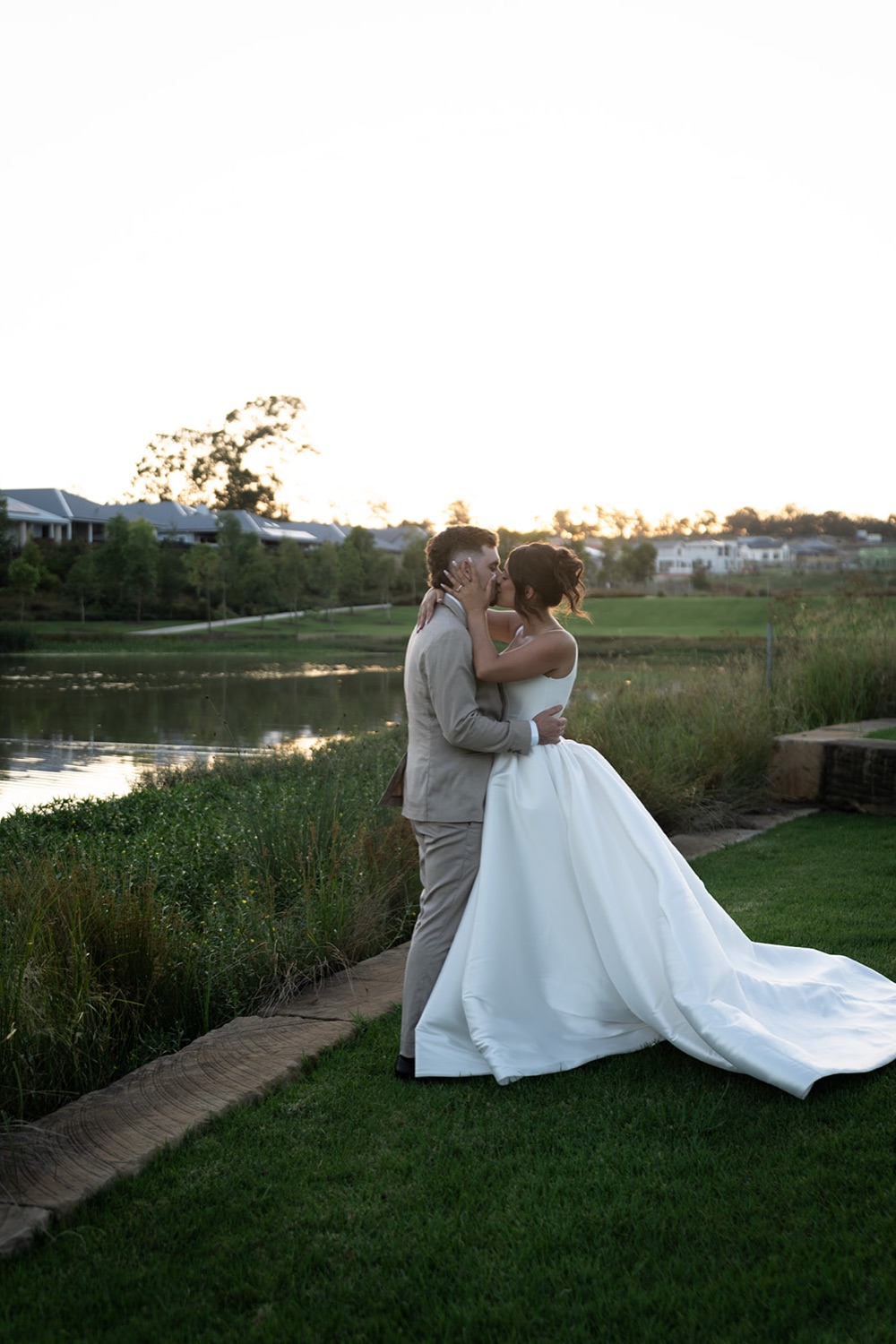 The couple by the lake at sunset. Jasmine & Joshua's wedding at The Lakehouse, North Richmond, Sydney