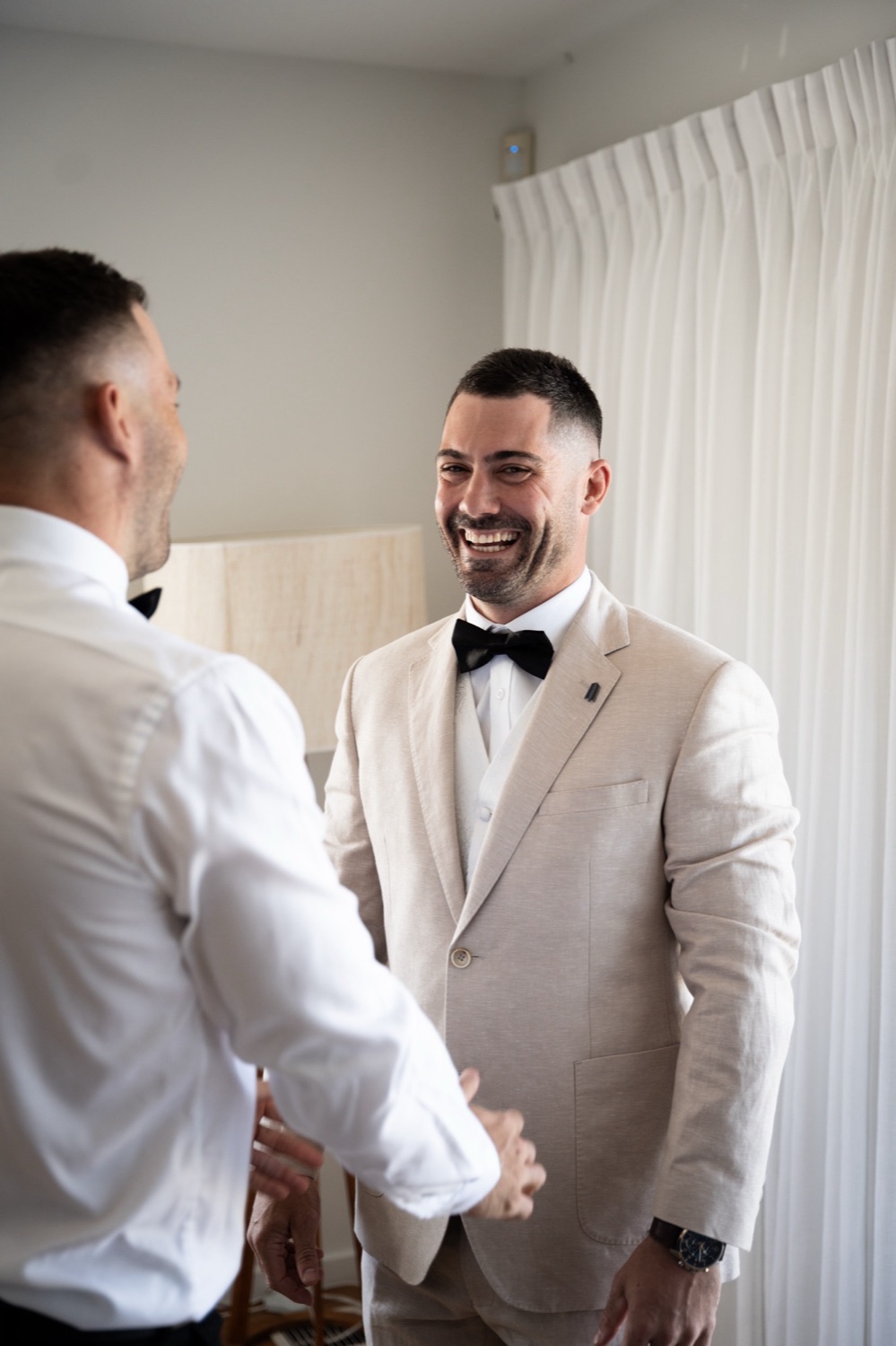 Laughing while getting ready. Jemma & Matthew's wedding at Caves Coastal Bar & Bungalows, Newcastle