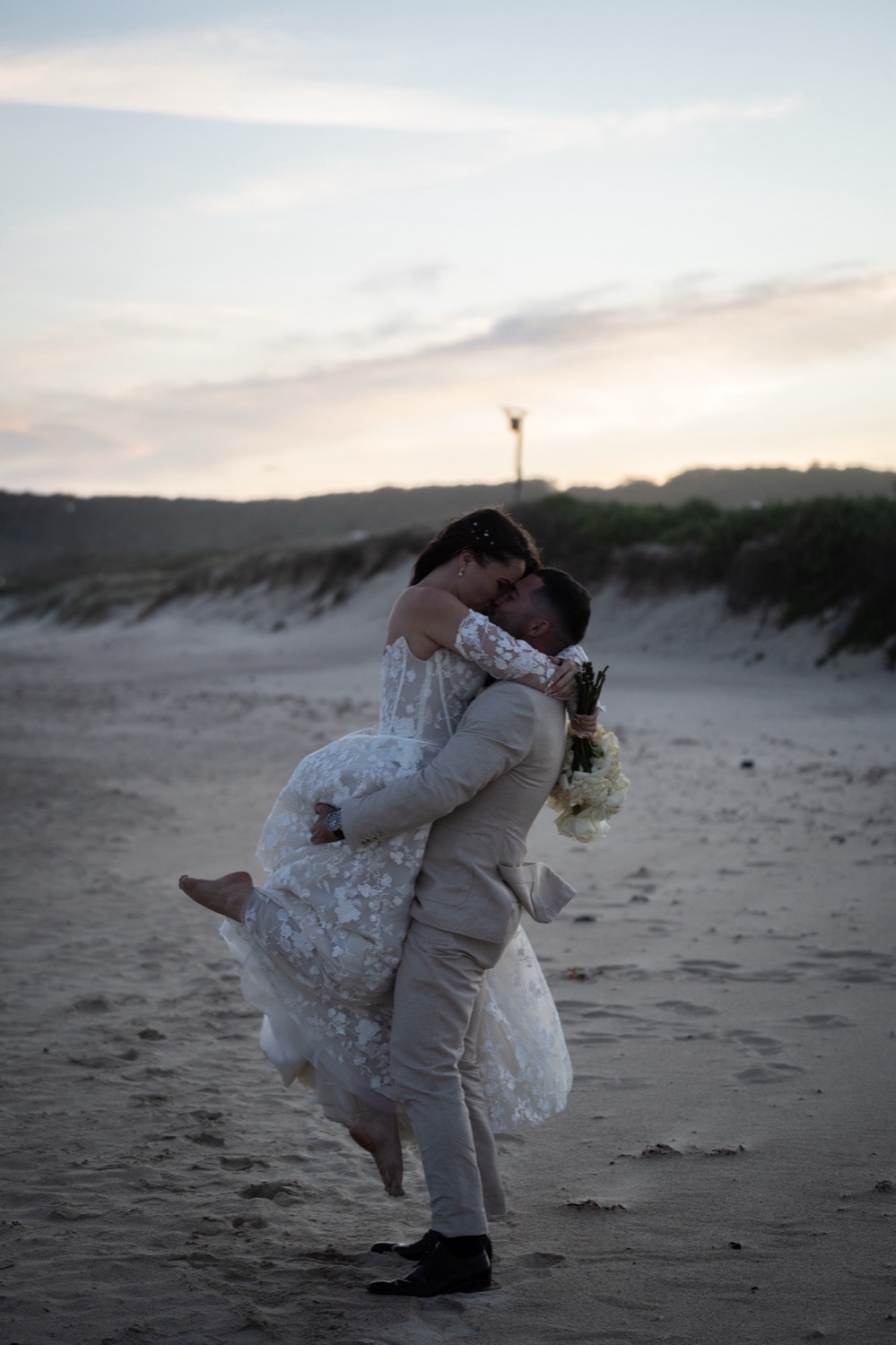 A lift on the sand dunes. Jemma & Matthew's wedding at Caves Coastal Bar & Bungalows, Newcastle