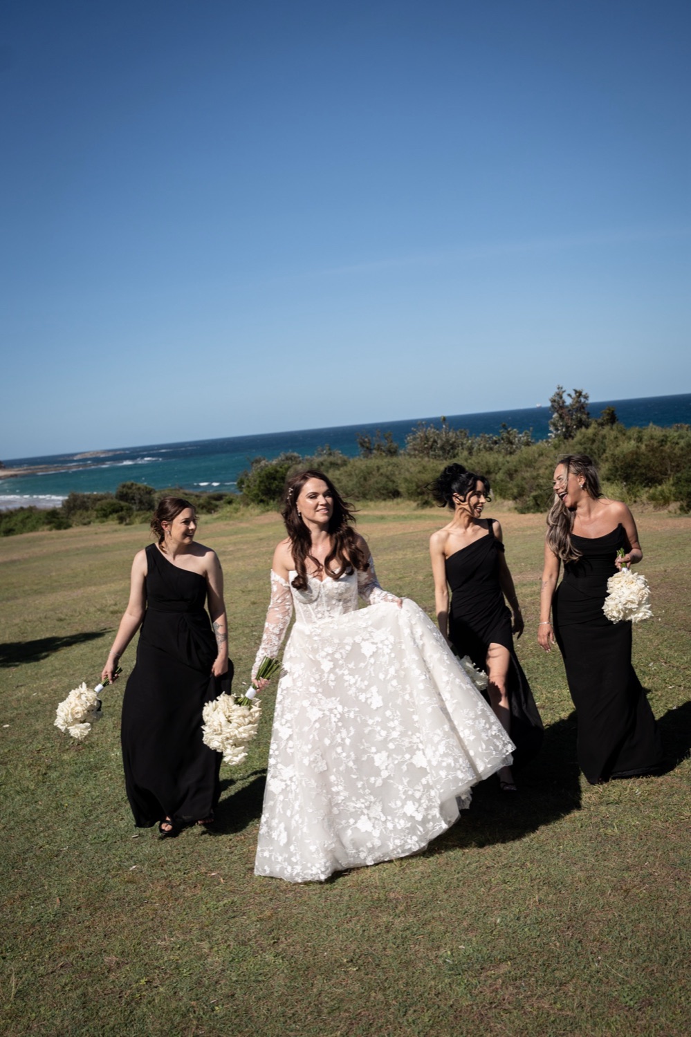 The wedding party on the headland. Jemma & Matthew's wedding at Caves Coastal Bar & Bungalows, Newcastle