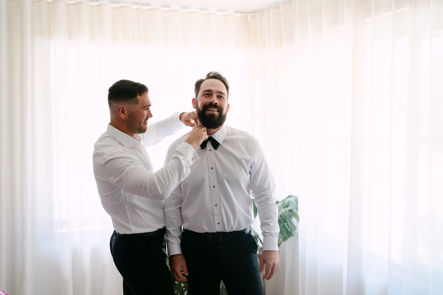 A bow tie straightened before the ceremony. Jessica & Ricky's wedding at Chapel of Light, Port Stephens