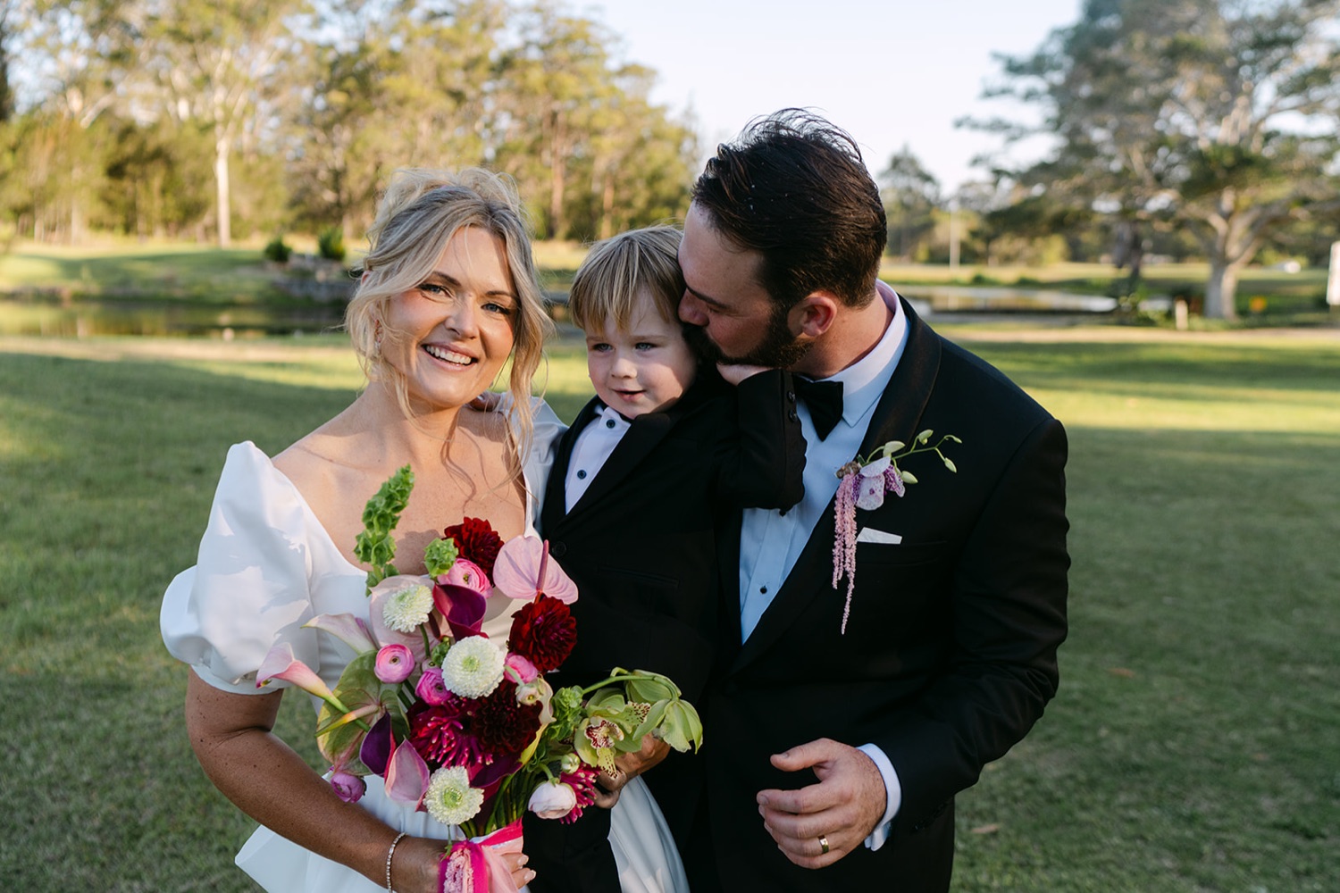 Laughing together on the lawn. Jessica & Ricky's wedding at Chapel of Light, Port Stephens