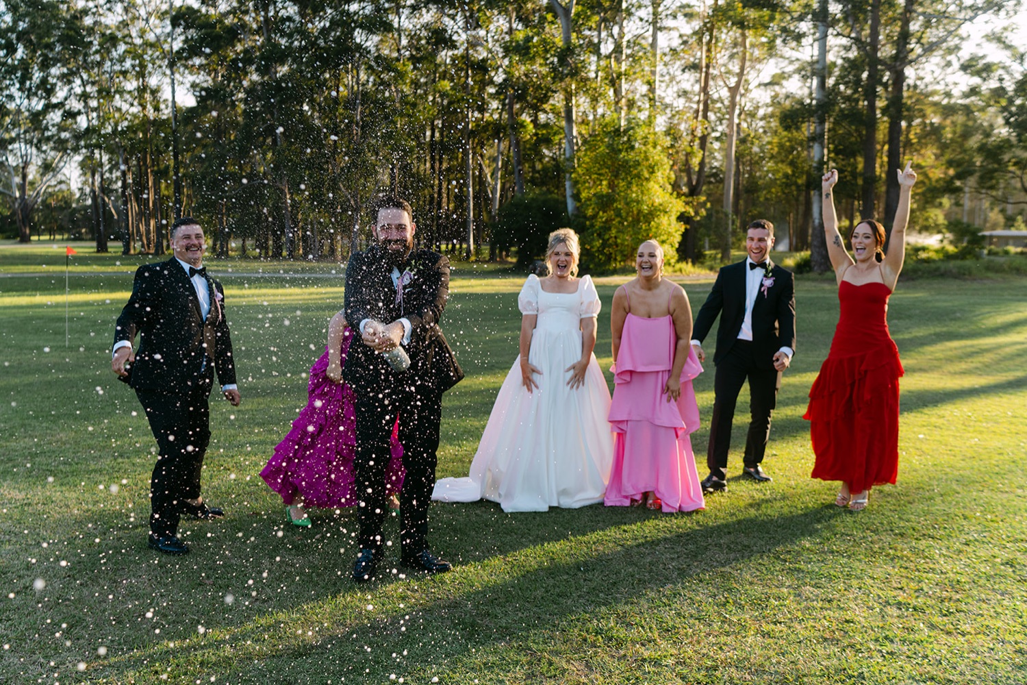 The wedding party in red and pink. Jessica & Ricky's wedding at Chapel of Light, Port Stephens