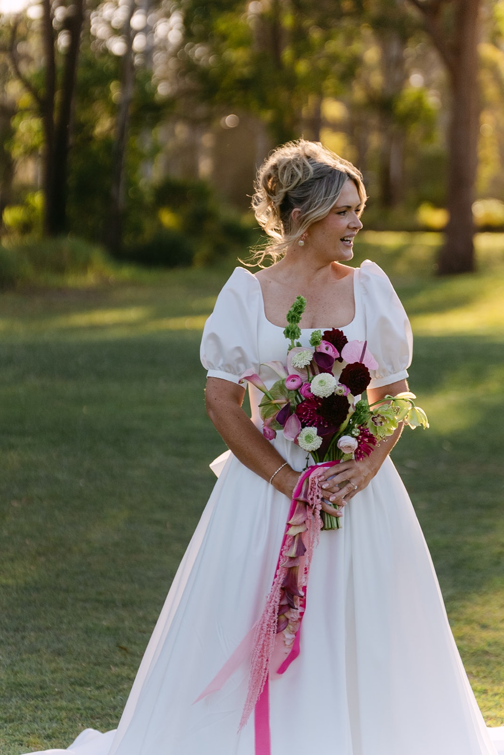 Portrait with ribbons trailing from the bouquet. Jessica & Ricky's wedding at Chapel of Light, Port Stephens