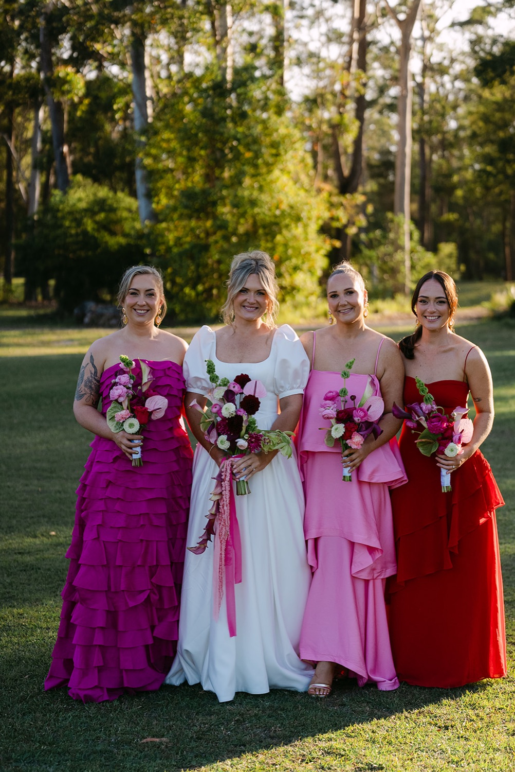 The wedding party in pink and red. Jessica & Ricky's wedding at Chapel of Light, Port Stephens