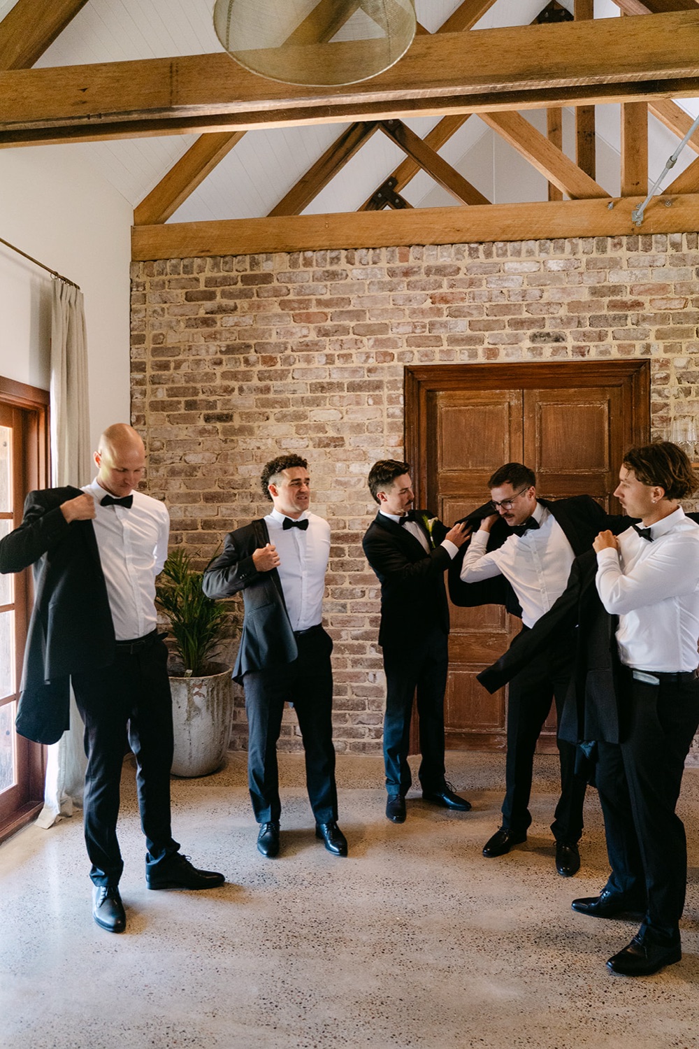 Getting ready under the timber beams. Jessie & Jack's wedding at Enzo, Hunter Valley