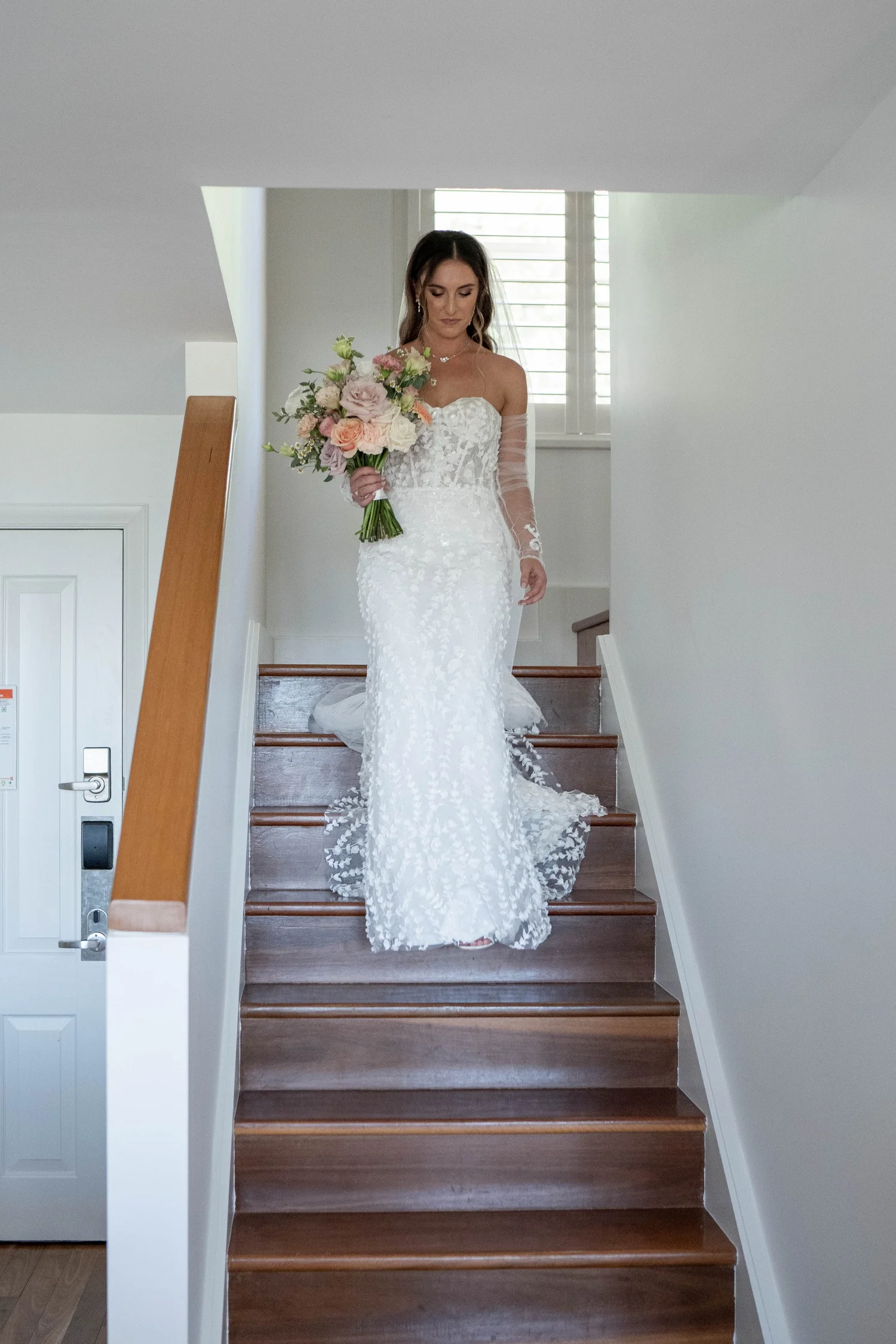 Coming down the stairs in the dress. Kaitlin & James's wedding at Oaks Cypress Lakes Resort, Hunter Valley