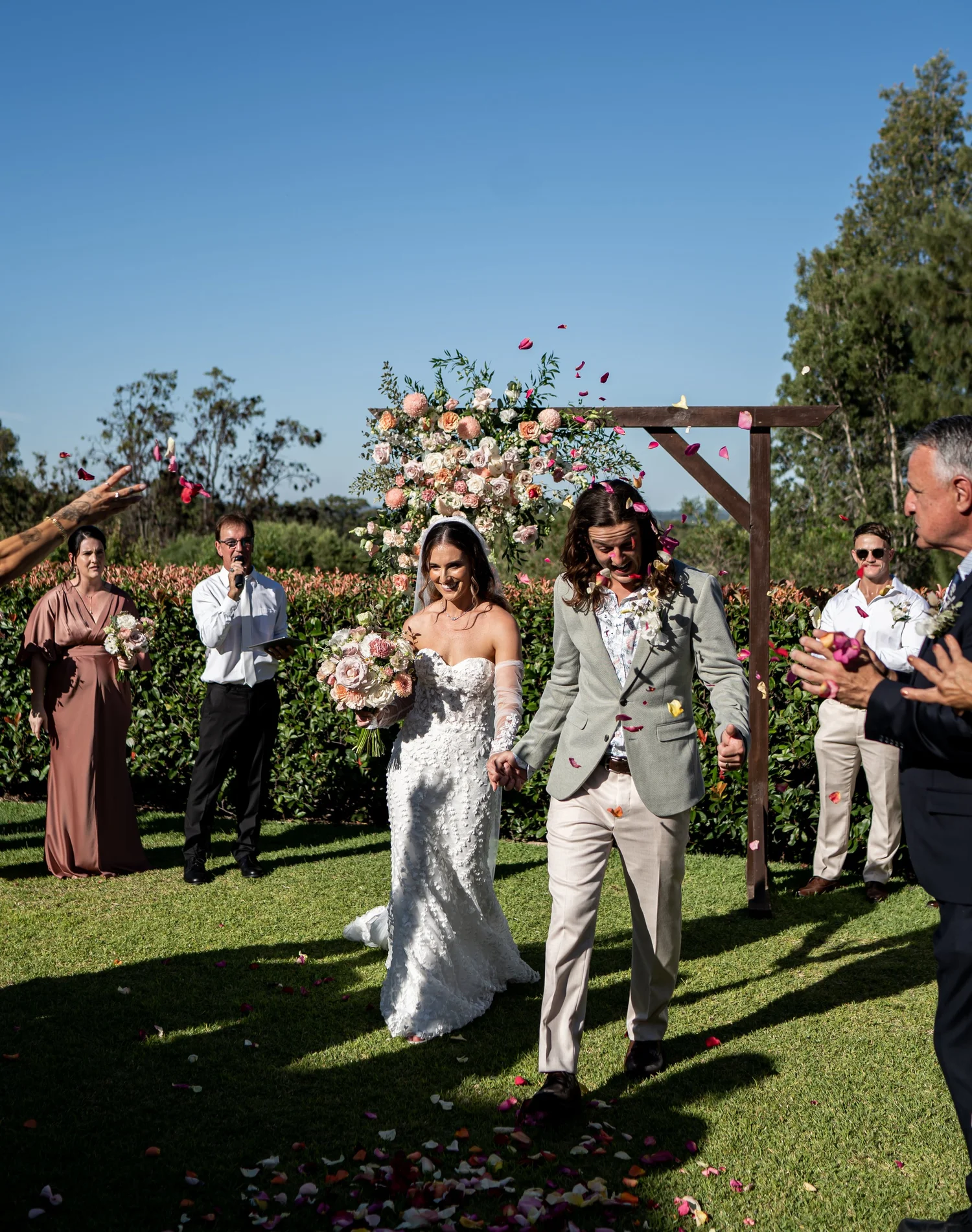 The ceremony on the lawn. Kaitlin & James's wedding at Oaks Cypress Lakes Resort, Hunter Valley