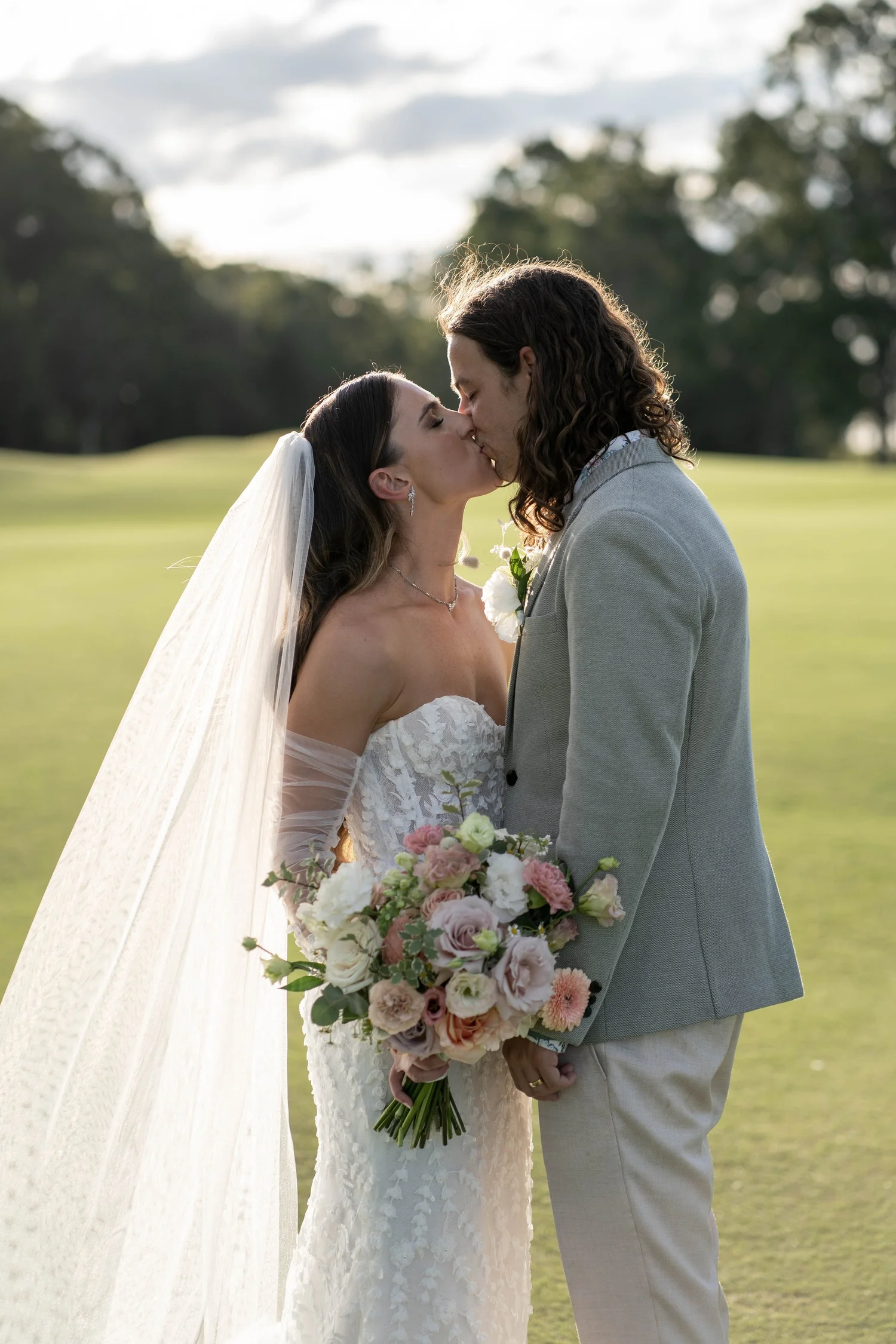 A kiss on the fairway. Kaitlin & James's wedding at Oaks Cypress Lakes Resort, Hunter Valley