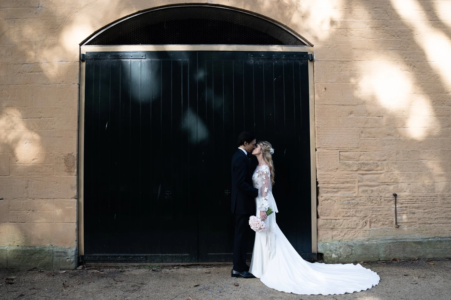 The couple by the sandstone stables. Kat & Aaryn's wedding at Vaucluse House, Sydney