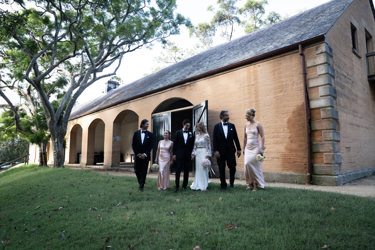 The wedding party on the lawn by the stables. Kat & Aaryn's wedding at Vaucluse House, Sydney