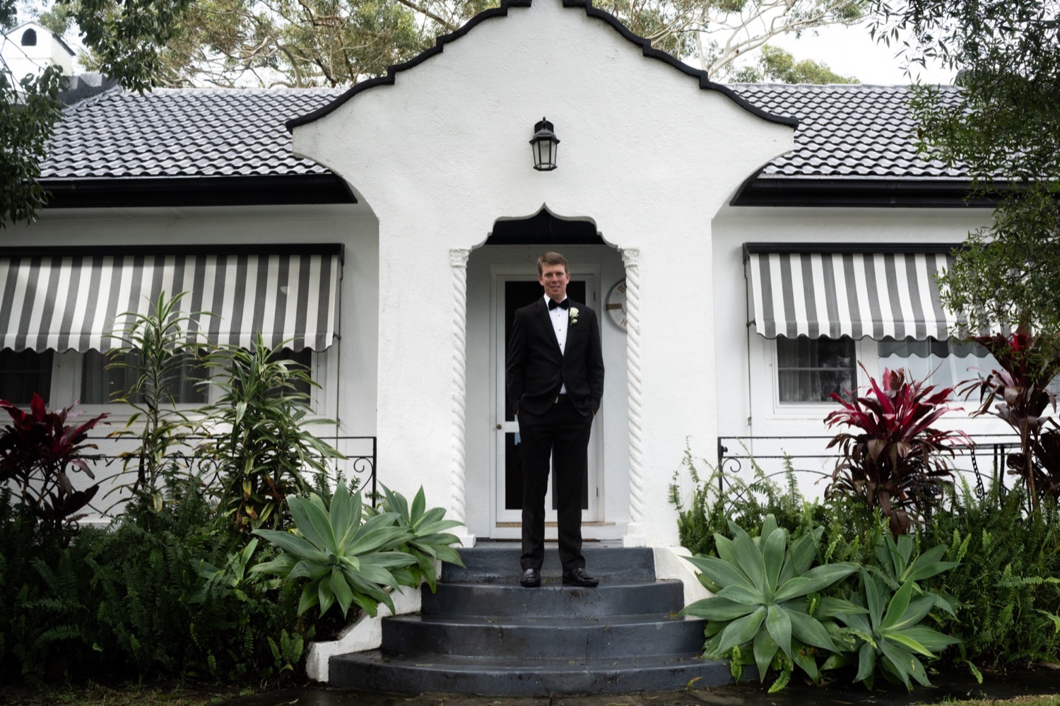 Waiting outside the white beach house. Lauren & Alasdair's wedding at Shoal Bay Beach, Port Stephens