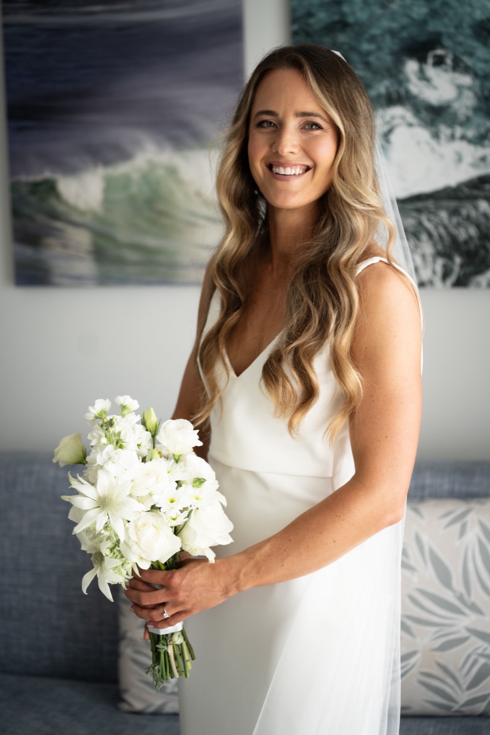 Portrait with a bouquet of white flowers. Lauren & Alasdair's wedding at Shoal Bay Beach, Port Stephens