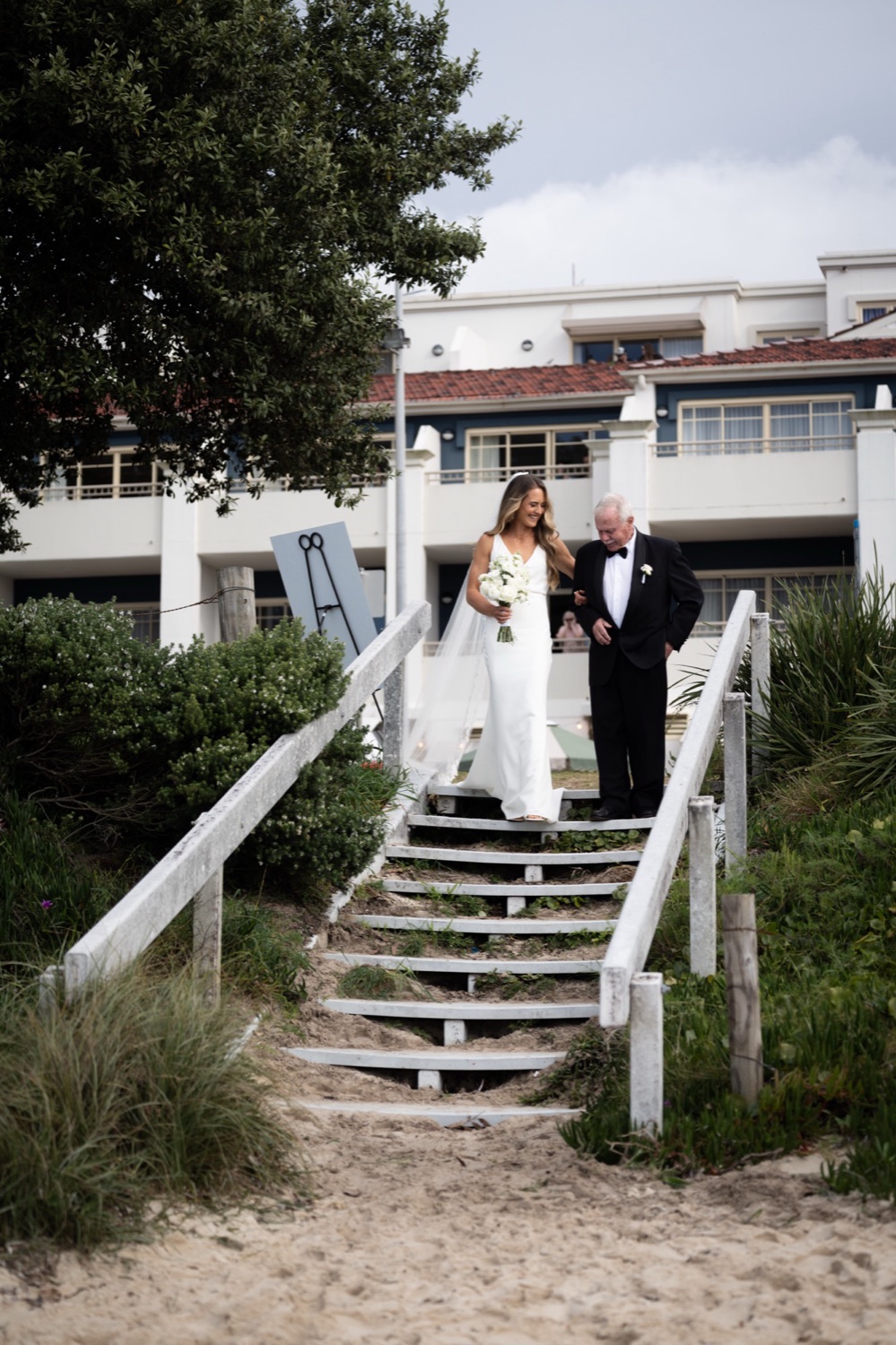 Walking down the steps to the beach. Lauren & Alasdair's wedding at Shoal Bay Beach, Port Stephens