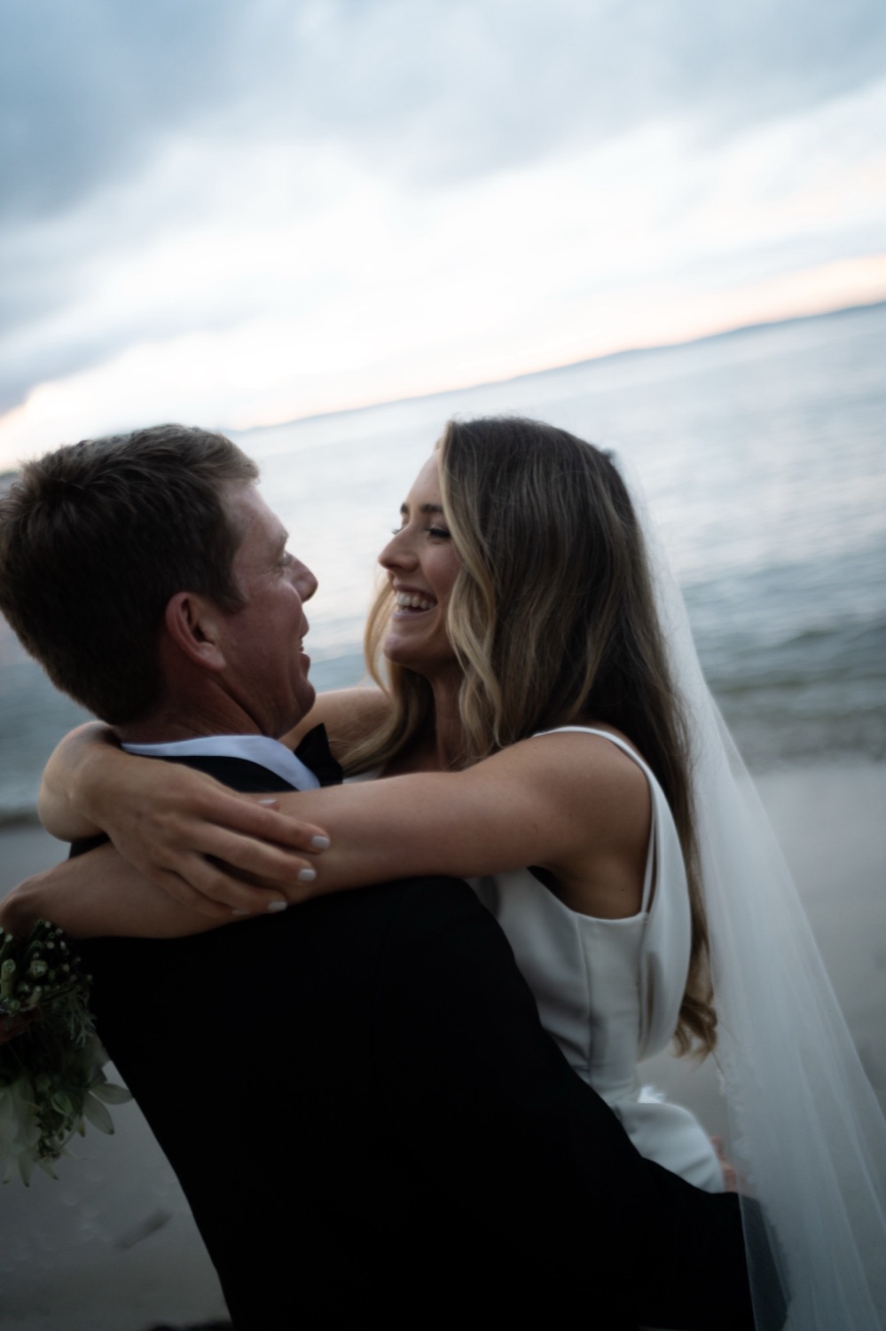 Laughing together on the beach. Lauren & Alasdair's wedding at Shoal Bay Beach, Port Stephens