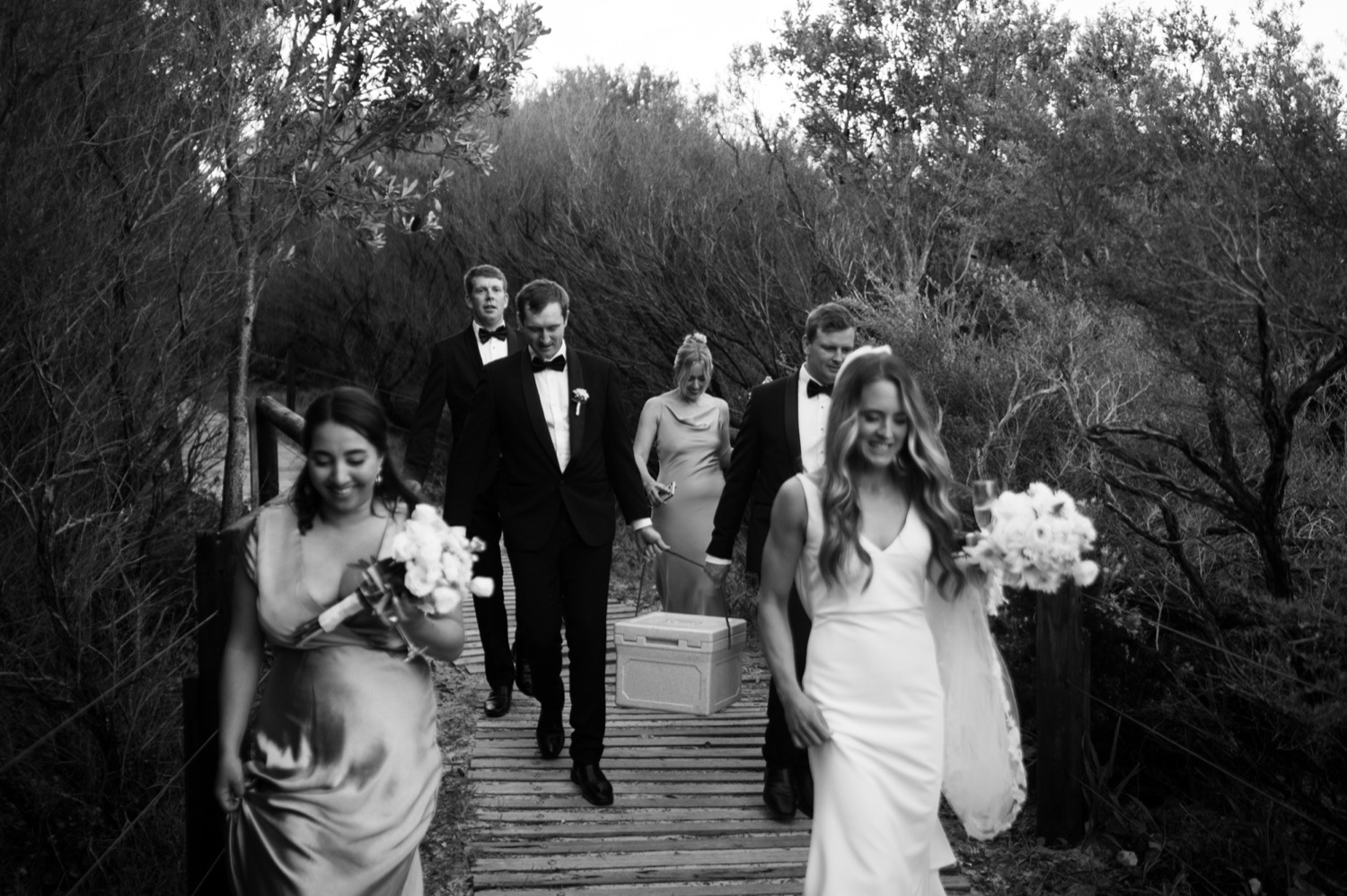 Walking down a bush path, in black and white. Lauren & Alasdair's wedding at Shoal Bay Beach, Port Stephens