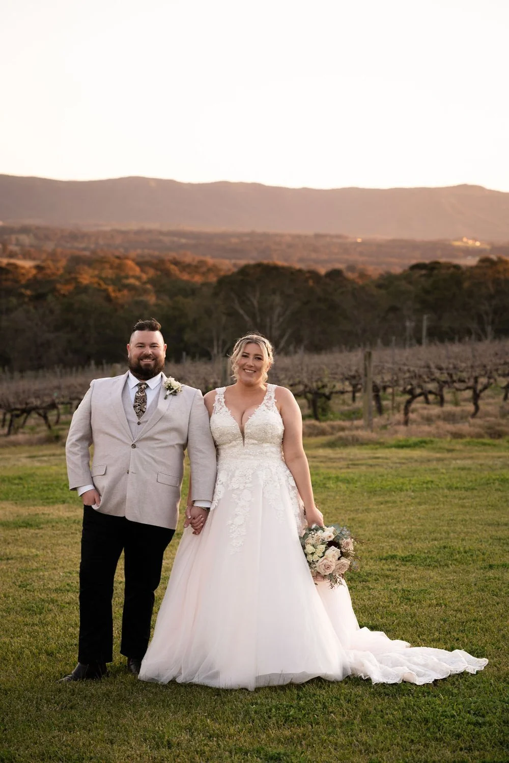 The couple on the hill with the valley behind. Lauren & Matt's wedding at Wandin Estate, Hunter Valley