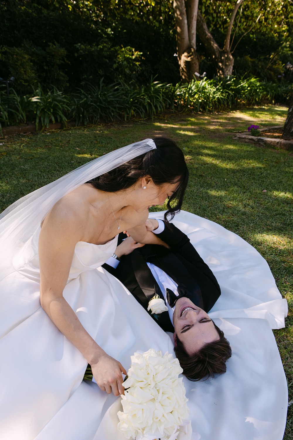Lying on the lawn in the dress. Phoebe & Cameron's wedding at Curzon Hall, Sydney