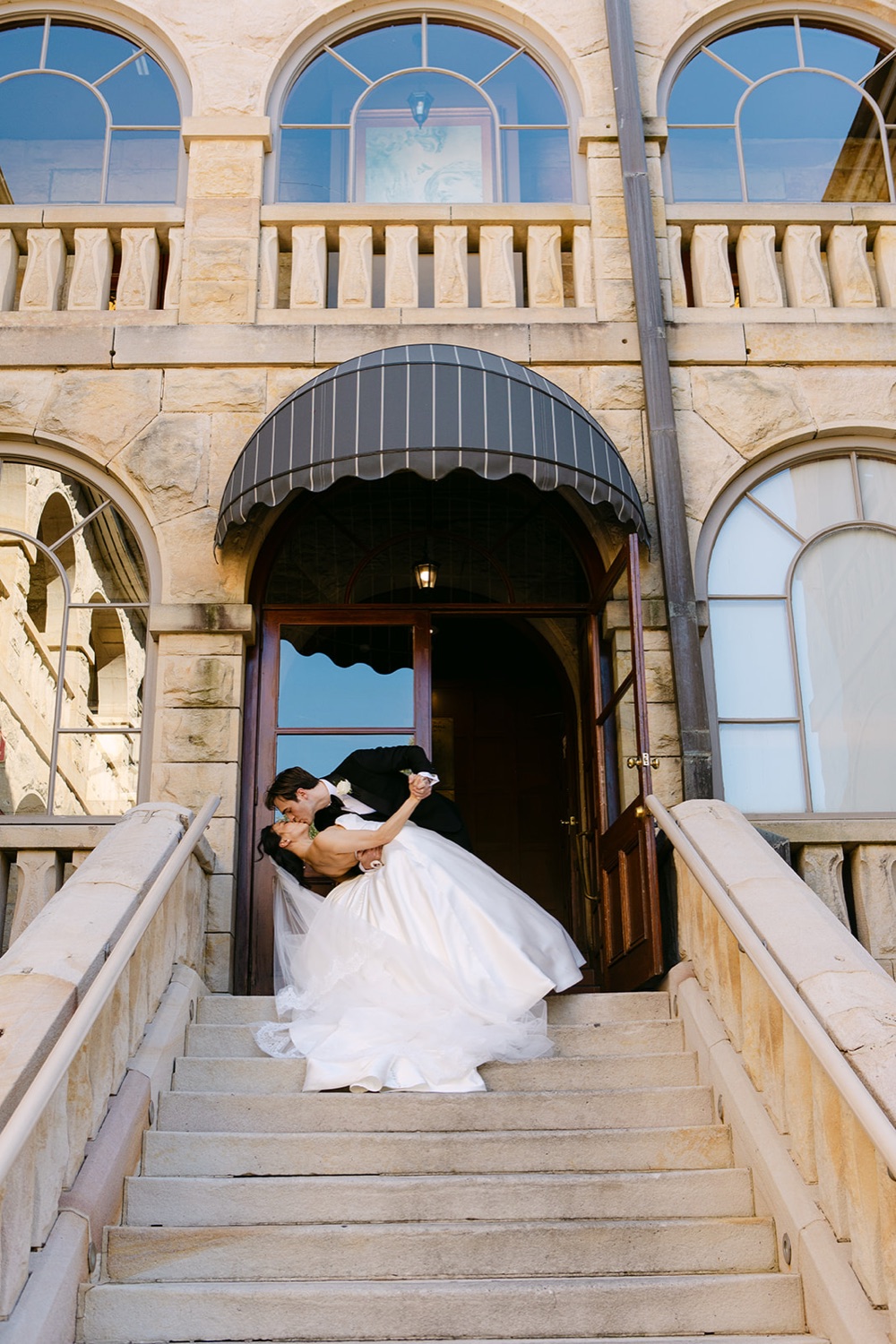 A dip on the sandstone stairs. Phoebe & Cameron's wedding at Curzon Hall, Sydney