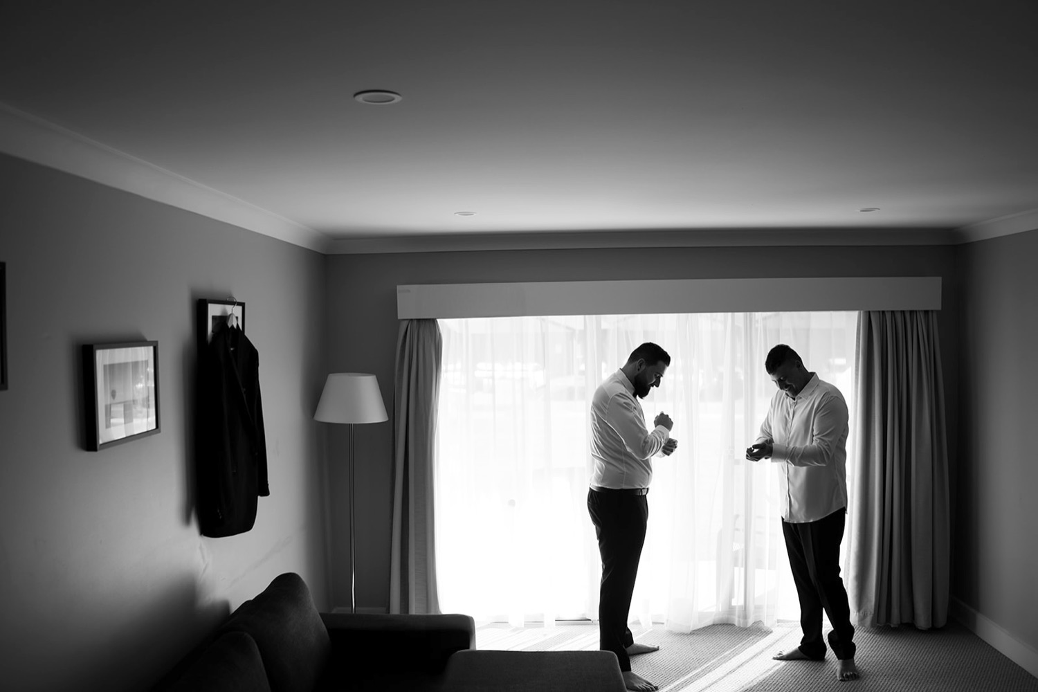 Getting ready by the window, in black and white. Sarah & Alex's wedding at Wandin Estate, Hunter Valley