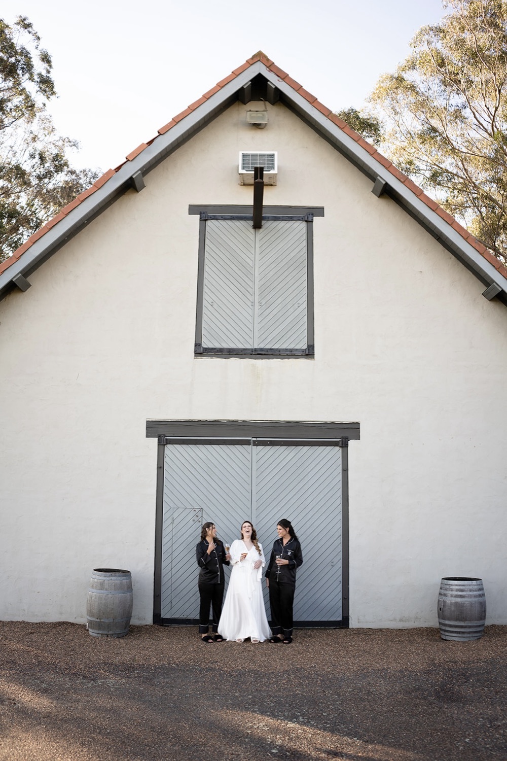 The couple in front of the white barn. Sarah & Alex's wedding at Wandin Estate, Hunter Valley