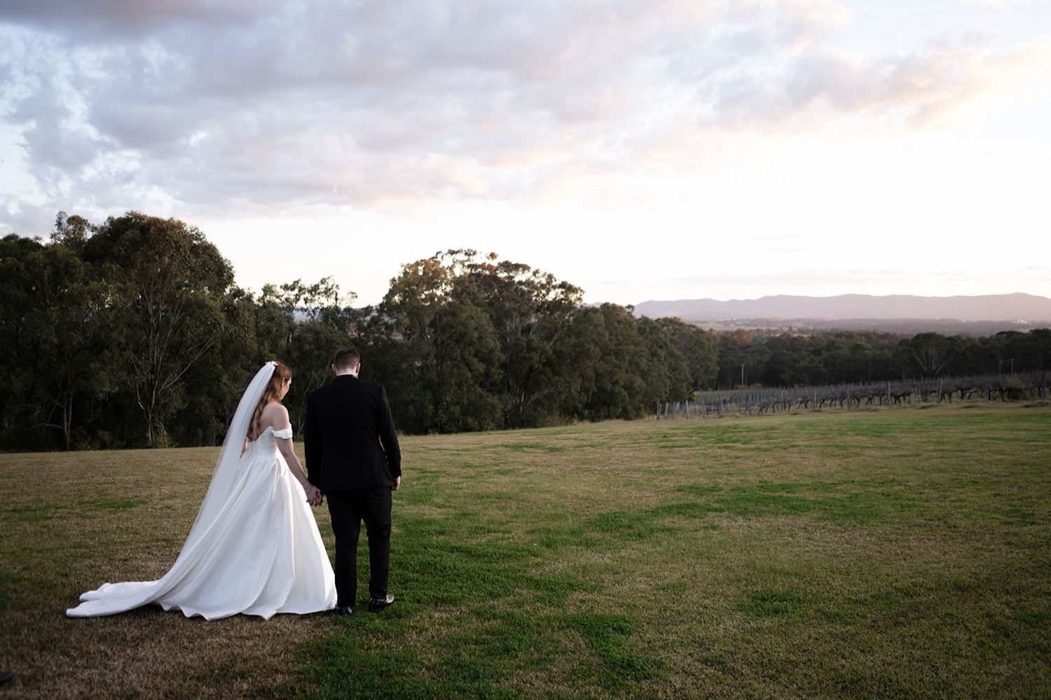 The couple on the hill at sunset. Sarah & Alex's wedding at Wandin Estate, Hunter Valley