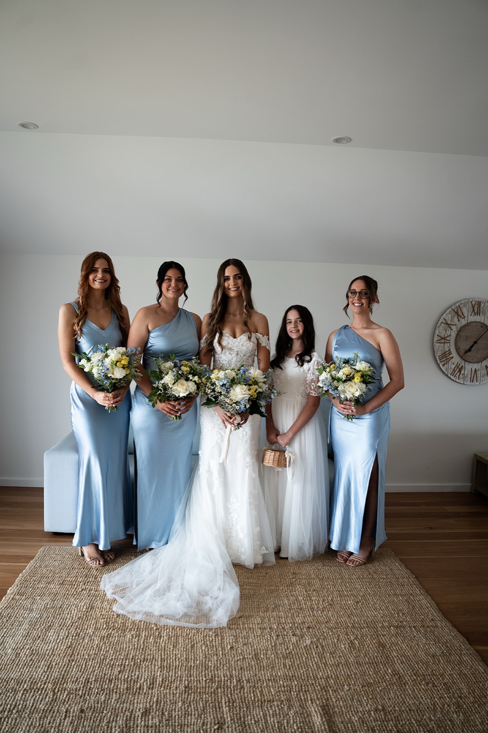 The wedding party in blue dresses. Sophie & Benjamin's wedding at Caves Coastal Bar & Bungalows, Newcastle