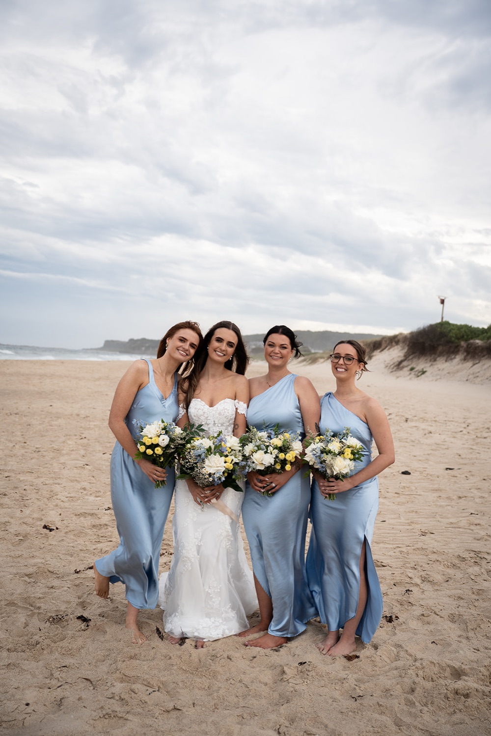 The wedding party on the beach. Sophie & Benjamin's wedding at Caves Coastal Bar & Bungalows, Newcastle