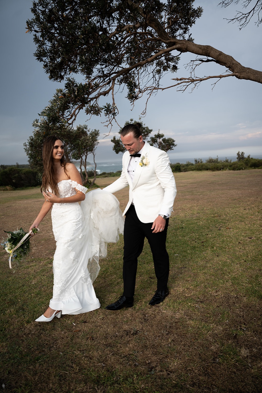 Under a tree on the headland. Sophie & Benjamin's wedding at Caves Coastal Bar & Bungalows, Newcastle