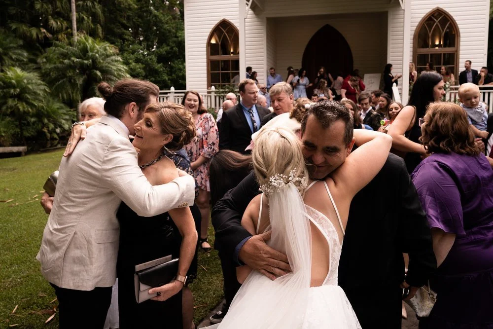 Hugs from guests after the ceremony. Tamara & Sam's wedding at Kantara House, Central Coast