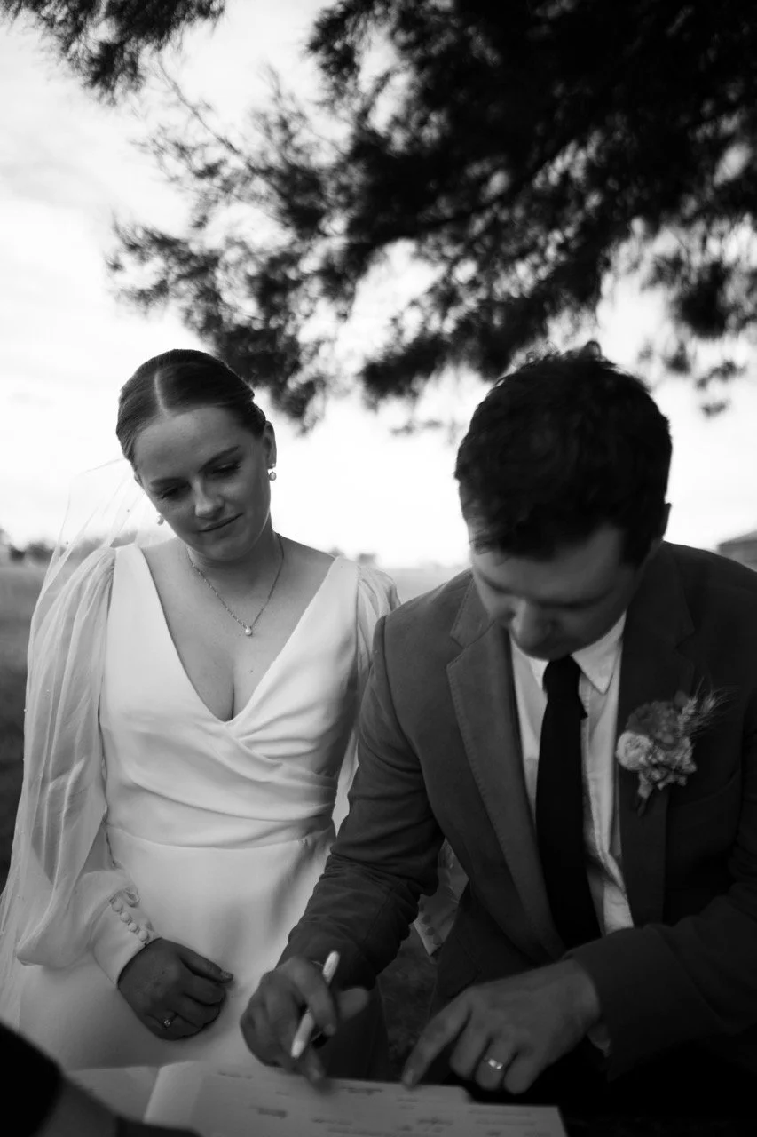 Signing the register, in black and white. Tara & Andrew's wedding at Emerald Hill, Regional NSW