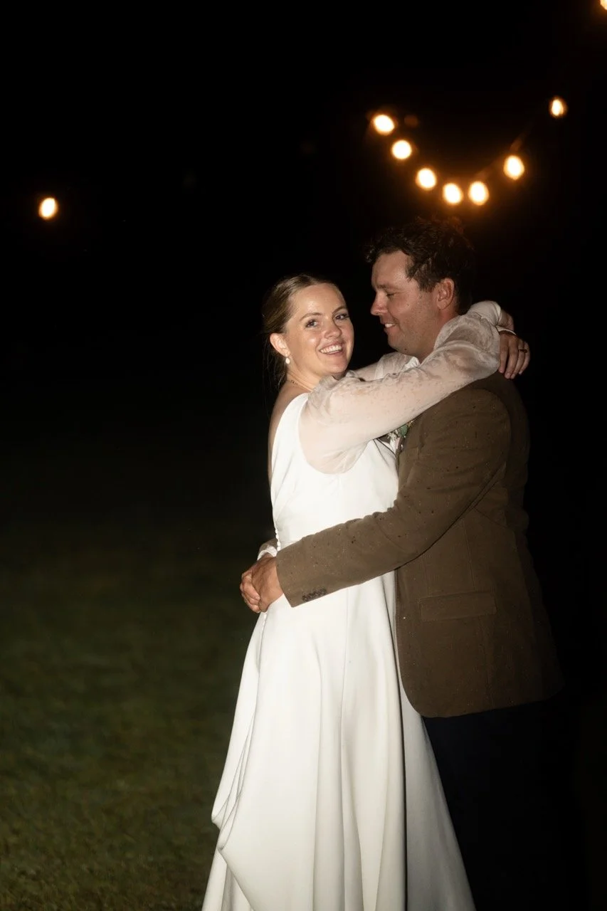 A dance under festoon lights at night. Tara & Andrew's wedding at Emerald Hill, Regional NSW