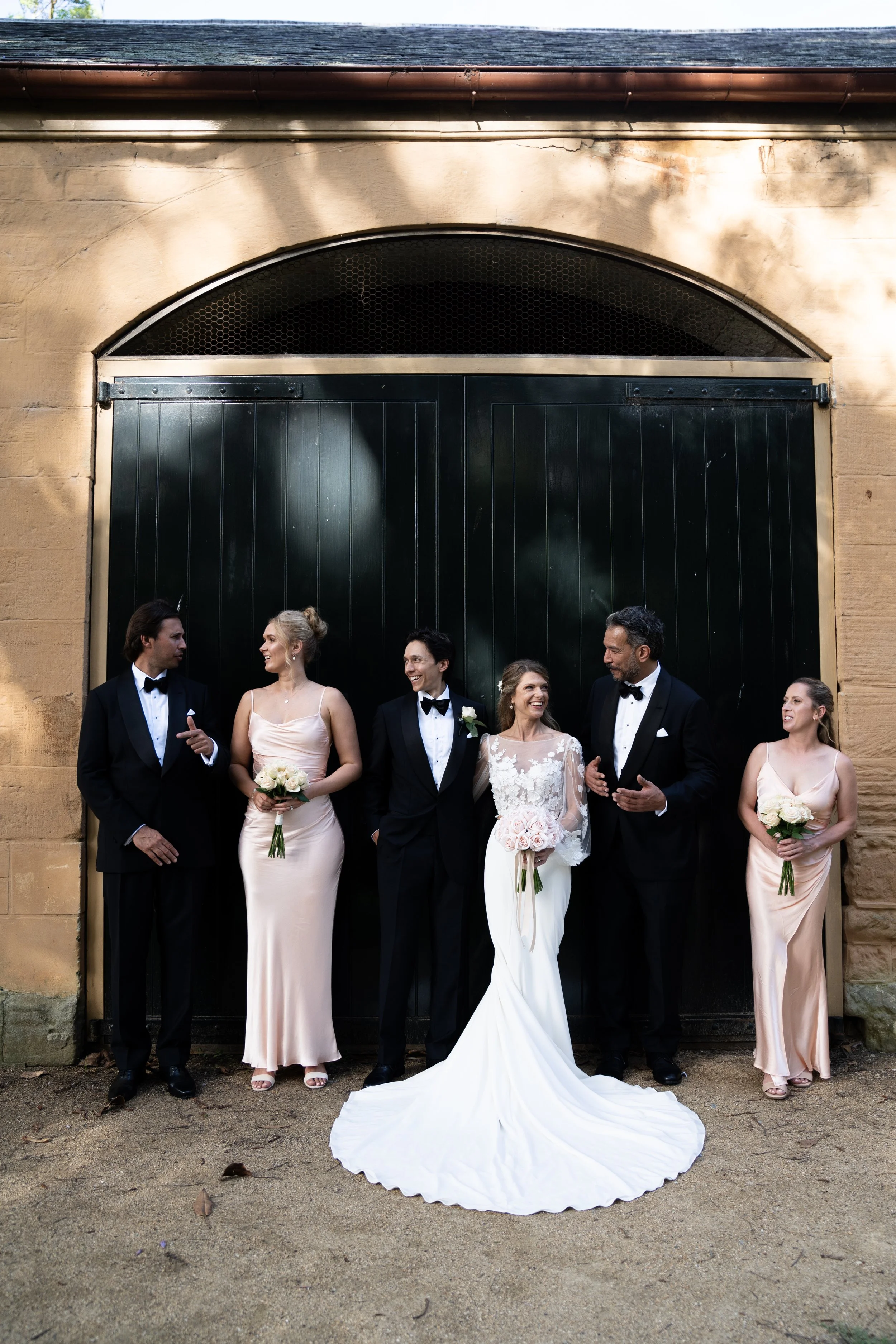 The wedding party at the arched stable doors. Kat & Aaryn's wedding at Vaucluse House, Sydney