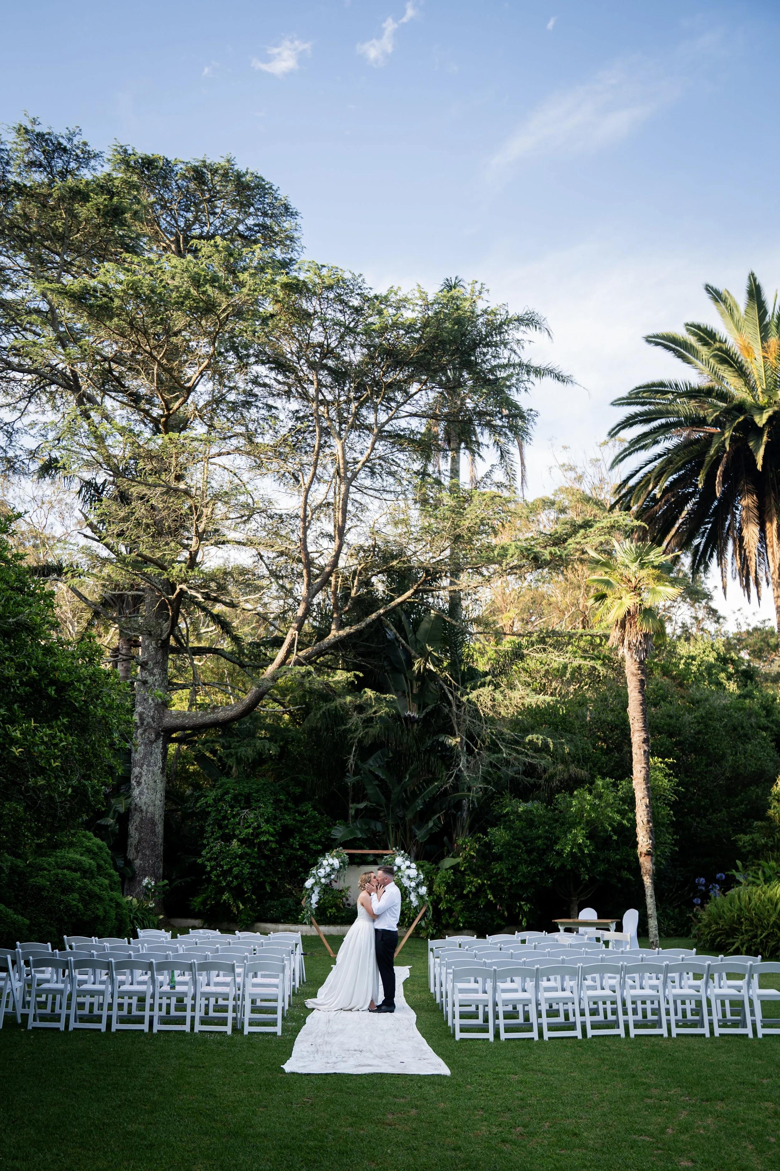 A ceremony in a tropical garden with palms