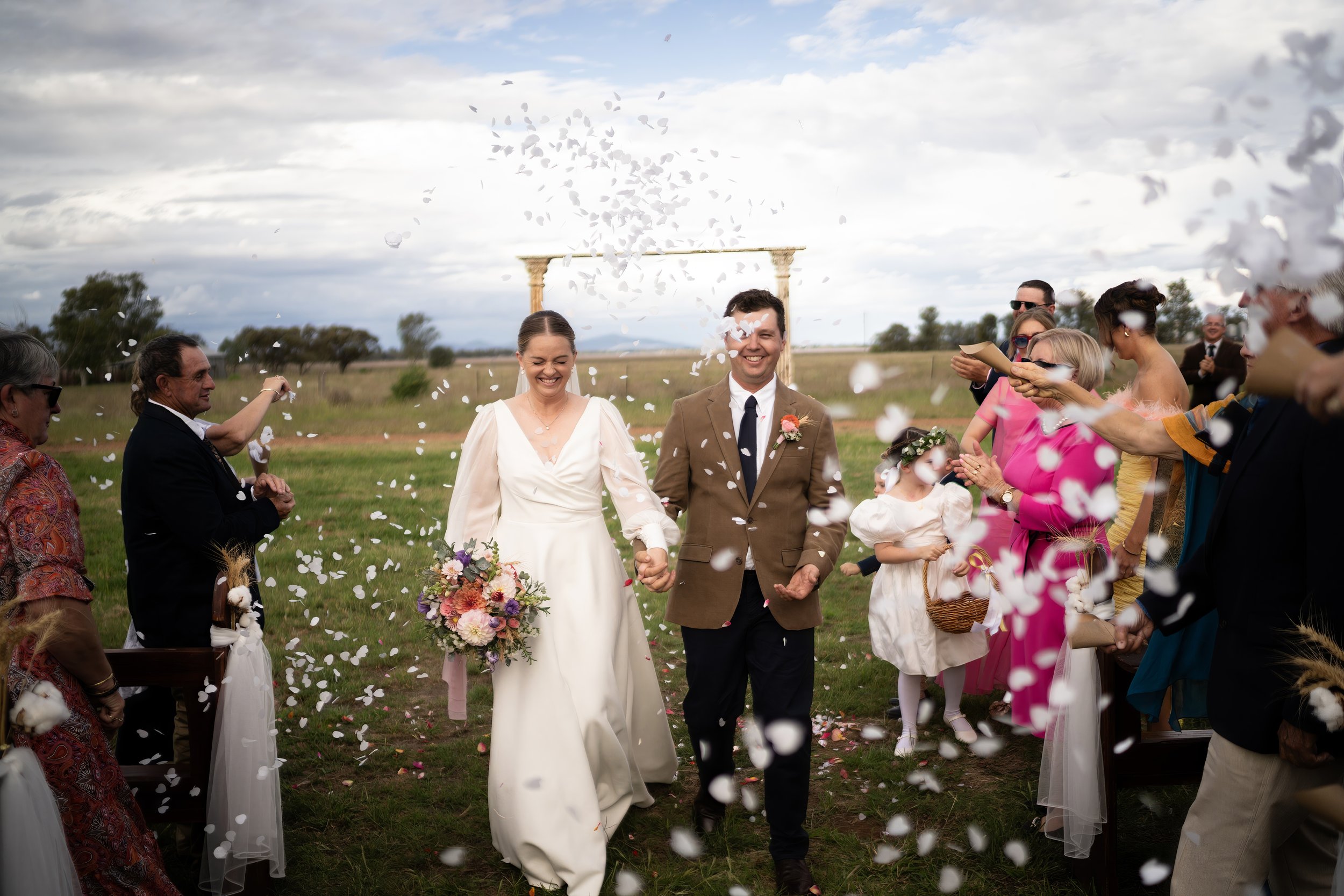 Walking back down the aisle through confetti. 's wedding at unknown, unknown