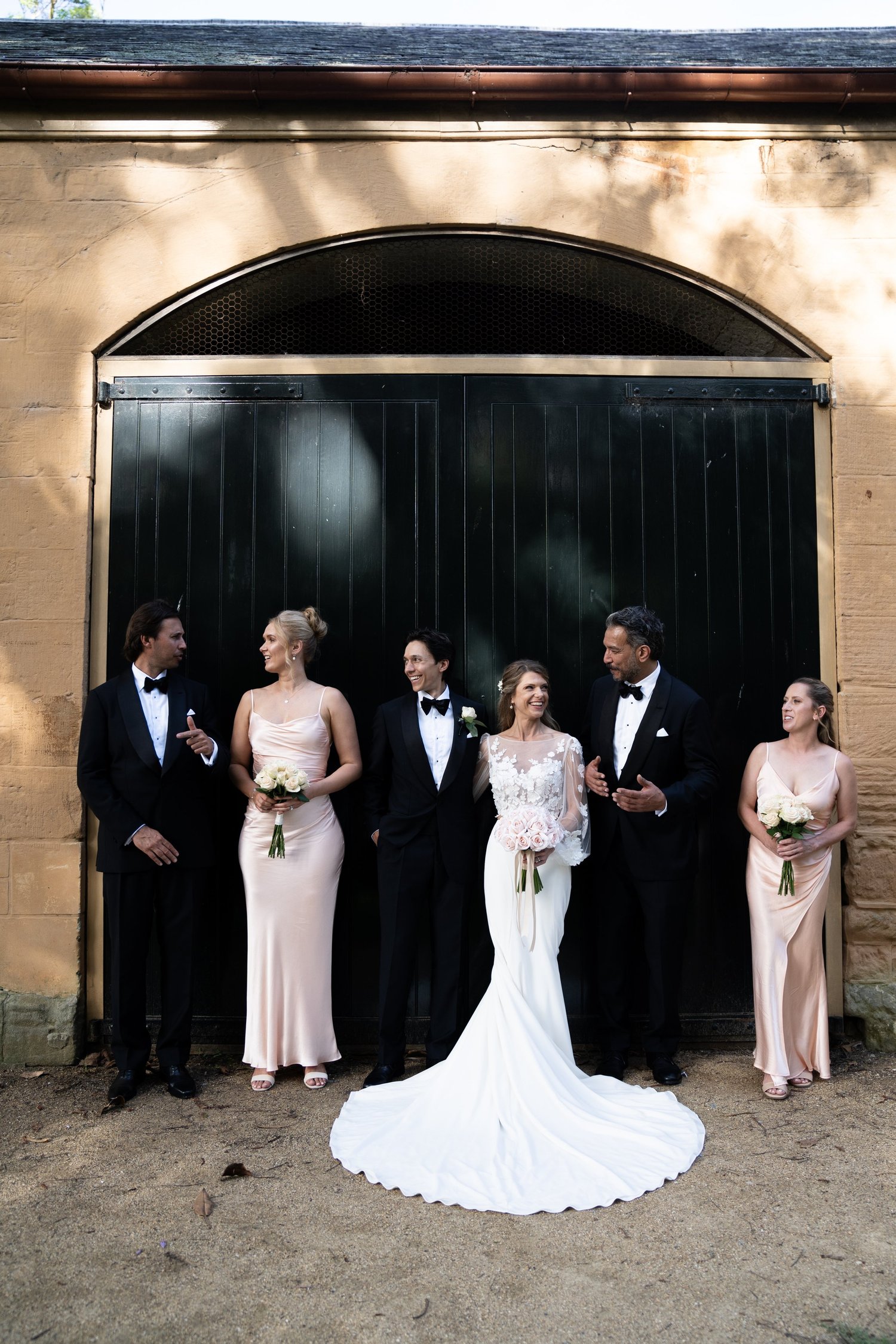 The wedding party at the arched stable doors. Kat & Aaryn's wedding at Vaucluse House, Sydney