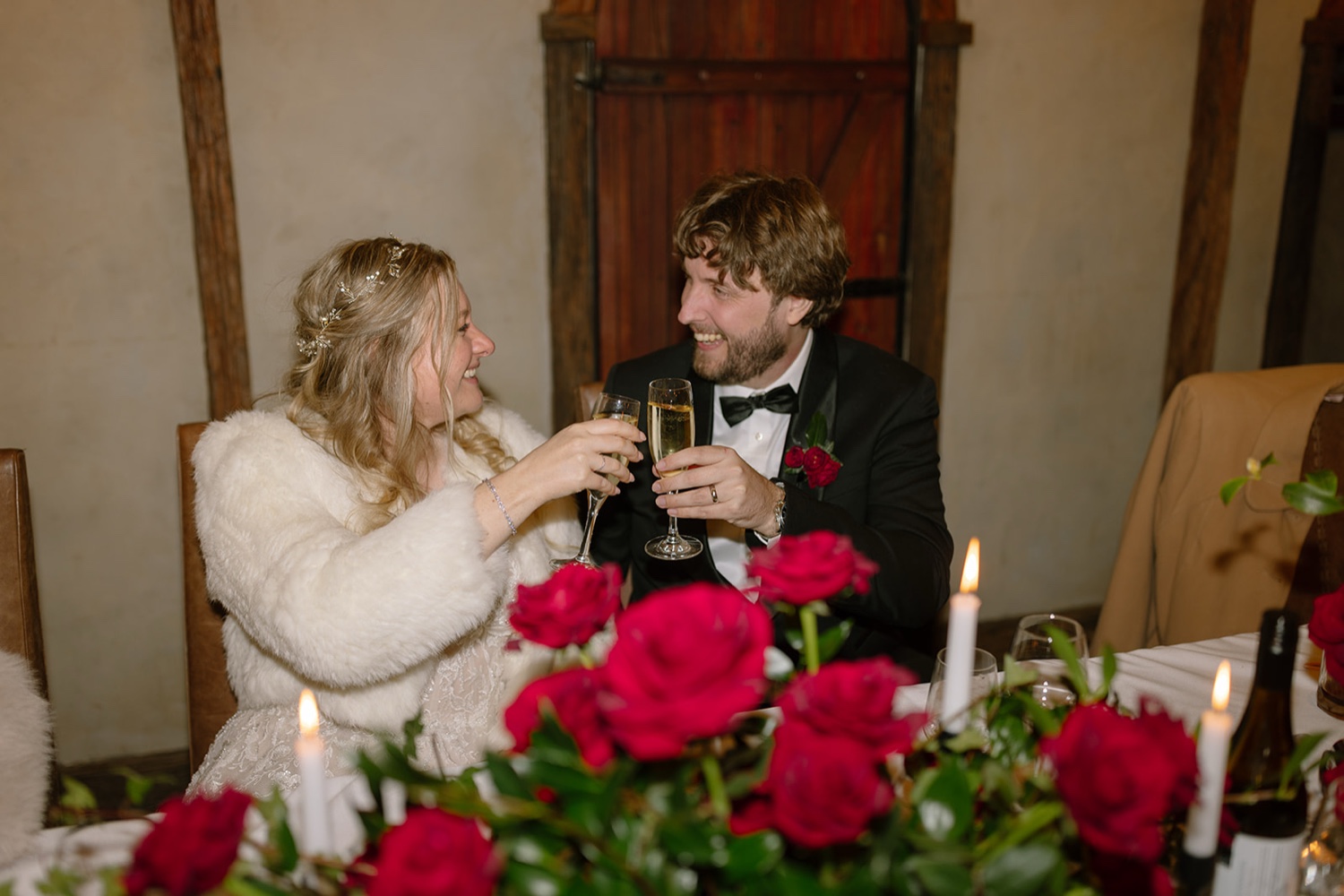 Chris and Casey raising a toast at their wedding