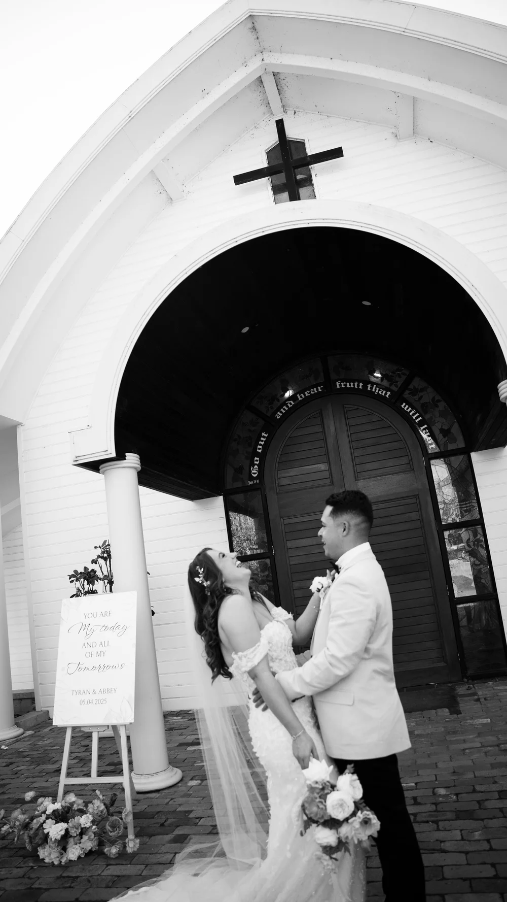 The couple at the white chapel door, in black and white