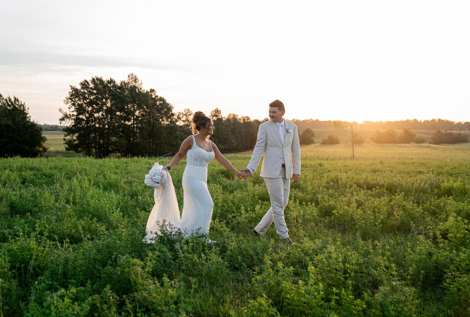 The couple in a field at sunset. 's wedding at unknown, unknown