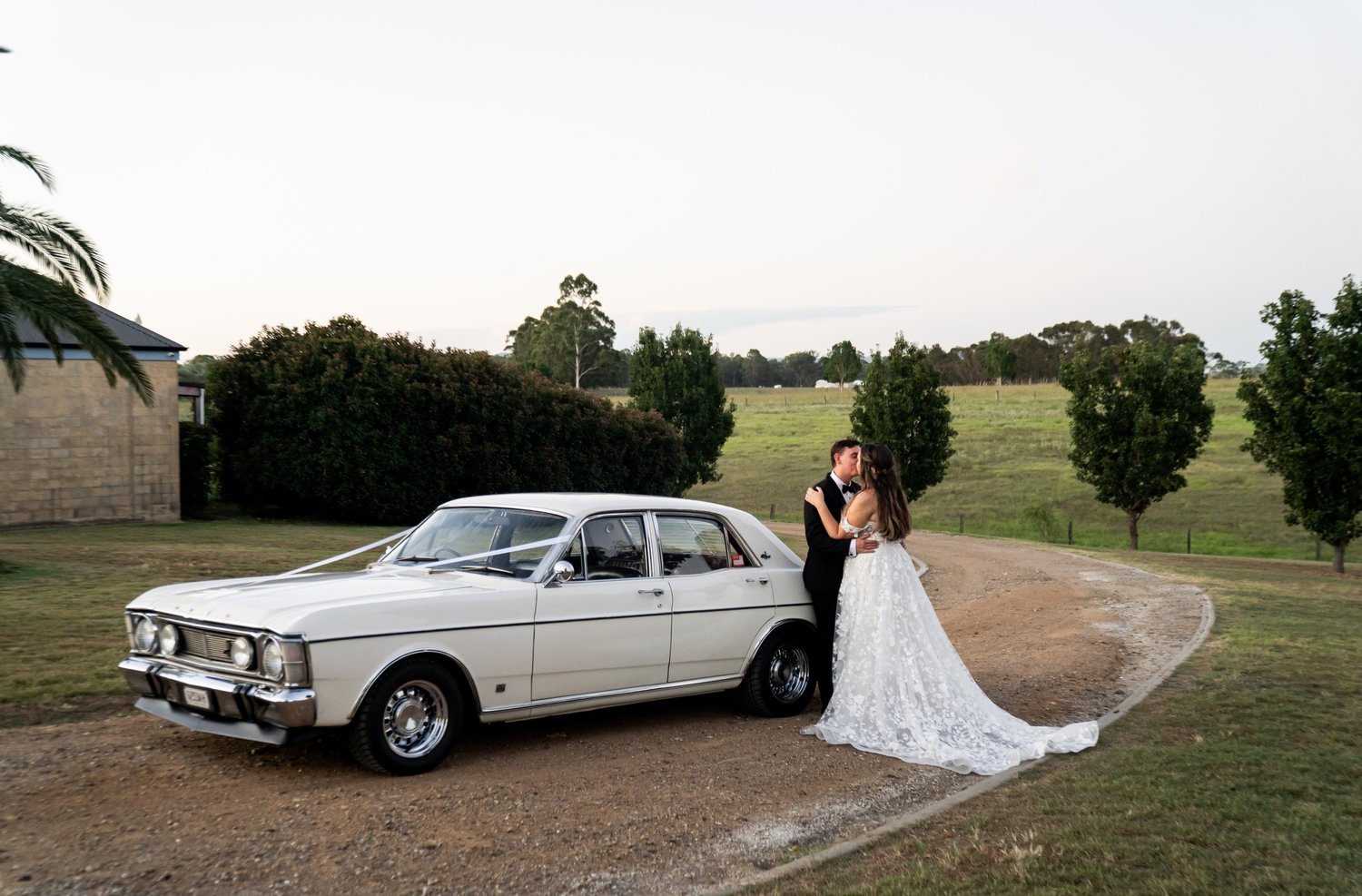 The couple with a vintage car. 's wedding at unknown, unknown